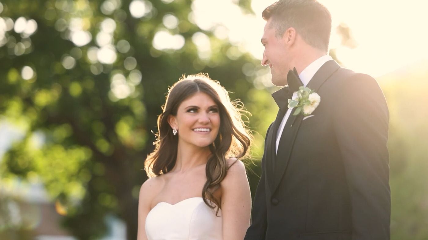Bride and groom smiling in golden evening light